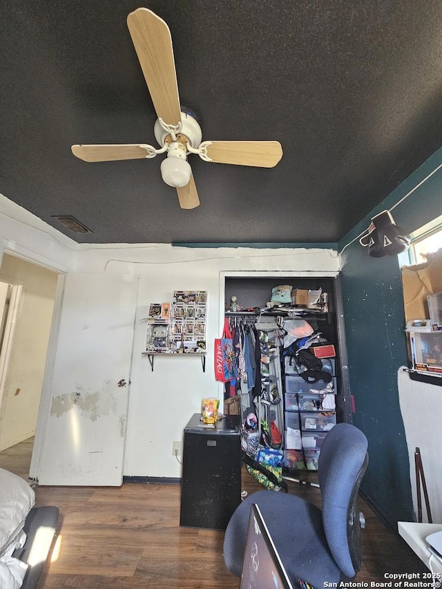 office featuring ceiling fan, dark hardwood / wood-style flooring, and a textured ceiling