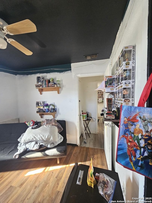 bedroom with ceiling fan and wood-type flooring