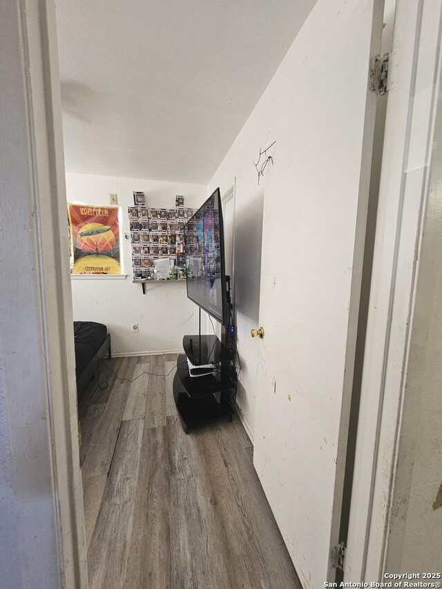 corridor with hardwood / wood-style floors