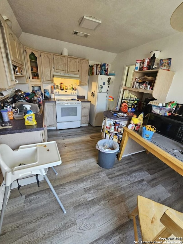 kitchen with white appliances, a textured ceiling, sink, light brown cabinets, and light hardwood / wood-style flooring