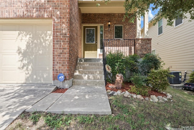 entrance to property with covered porch, cooling unit, and a garage