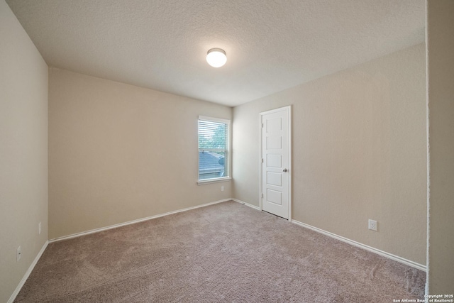 spare room with carpet floors and a textured ceiling