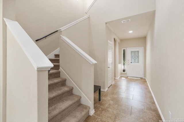 entryway with light tile patterned flooring