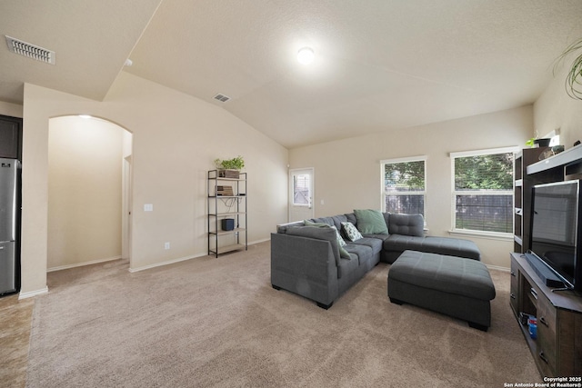 living room with light carpet and vaulted ceiling