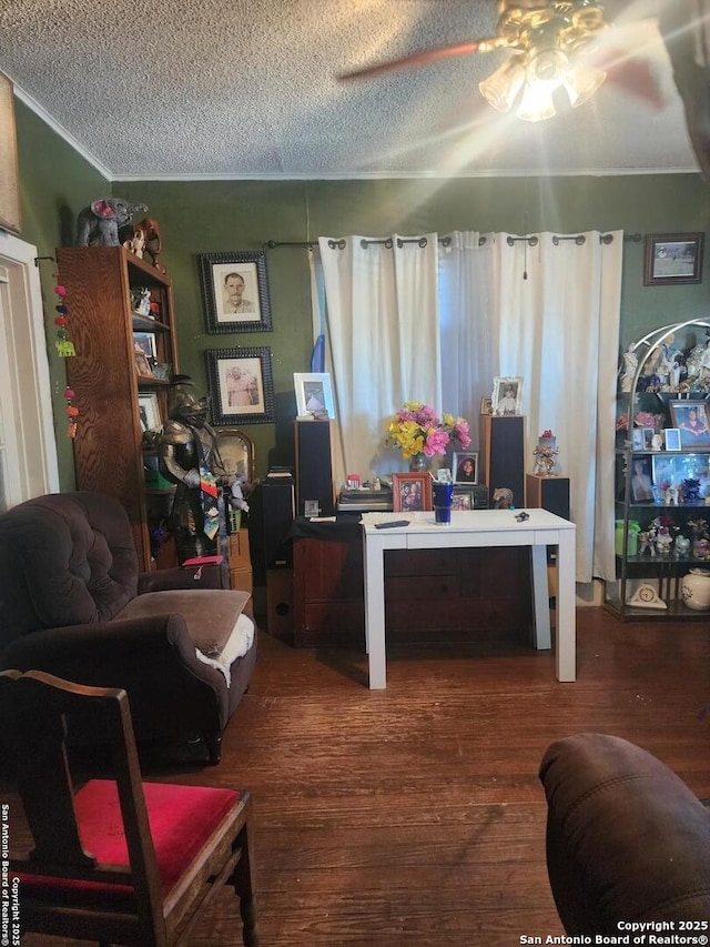 interior space featuring dark hardwood / wood-style floors, ceiling fan, and a textured ceiling