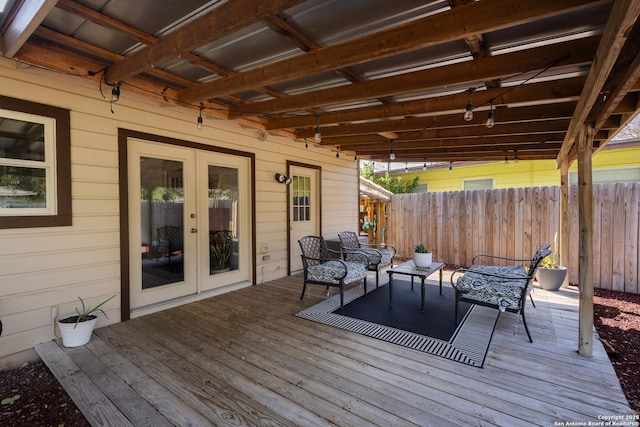 wooden terrace featuring an outdoor living space and french doors