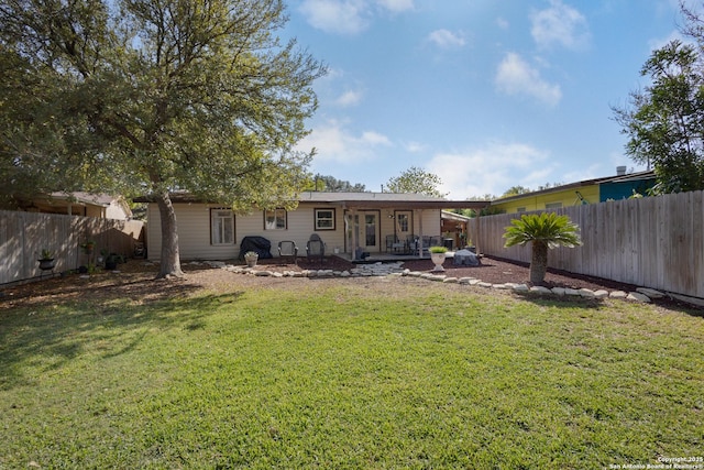 back of property featuring a patio area and a yard