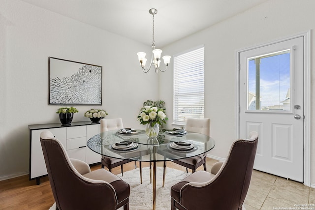 dining space featuring a chandelier and light tile patterned floors