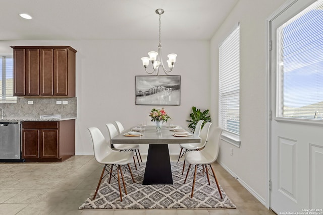 tiled dining space with a chandelier