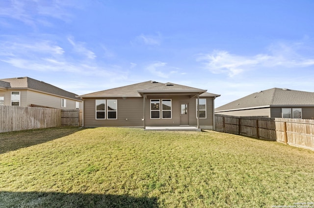 rear view of house with a lawn and a patio