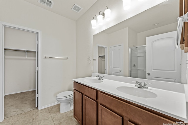 bathroom featuring tile patterned floors, vanity, an enclosed shower, and toilet