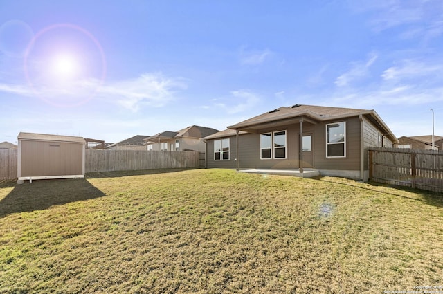 back of property featuring a patio, a lawn, and a shed