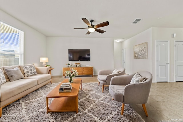 living room with ceiling fan and tile patterned flooring