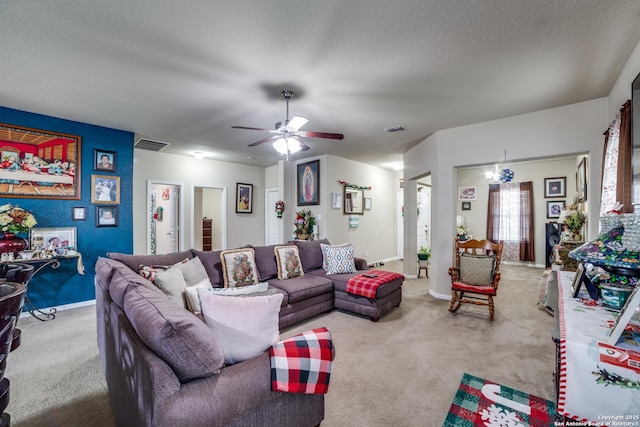 carpeted living room featuring ceiling fan with notable chandelier and a textured ceiling