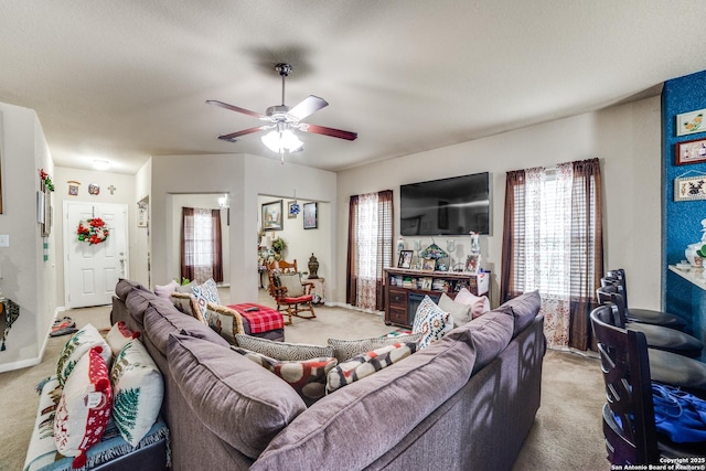 living room featuring light colored carpet and ceiling fan