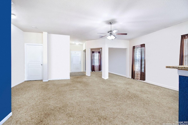 interior space with ceiling fan