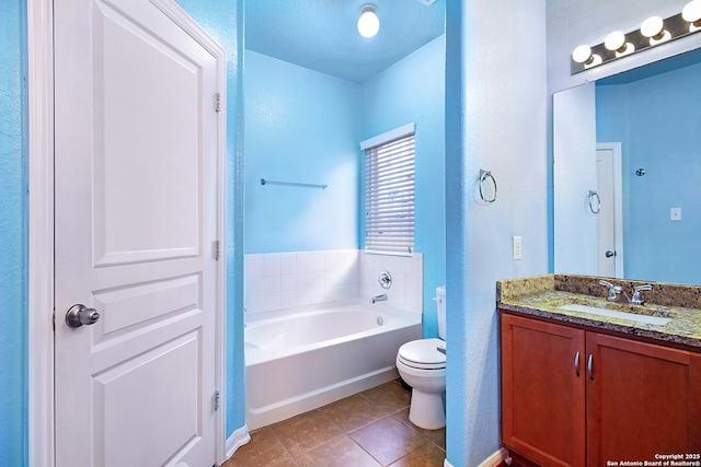 bathroom with tile patterned floors, a bathtub, vanity, and toilet