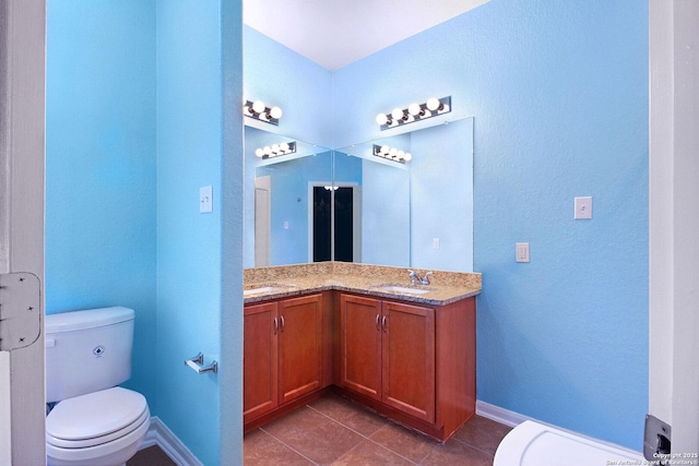 bathroom featuring tile patterned floors, vanity, and toilet