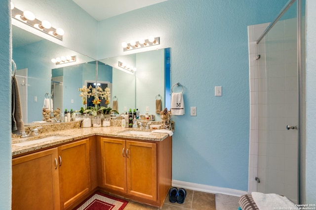 bathroom with tile patterned flooring, vanity, and walk in shower