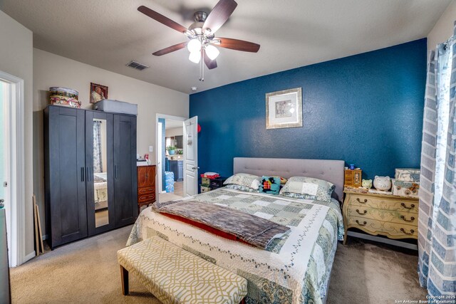 bedroom with connected bathroom, ceiling fan, carpet floors, and a textured ceiling