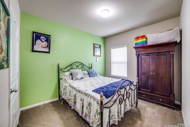 bedroom featuring carpet floors and a textured ceiling