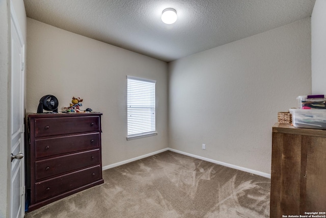 bedroom with a textured ceiling and light carpet