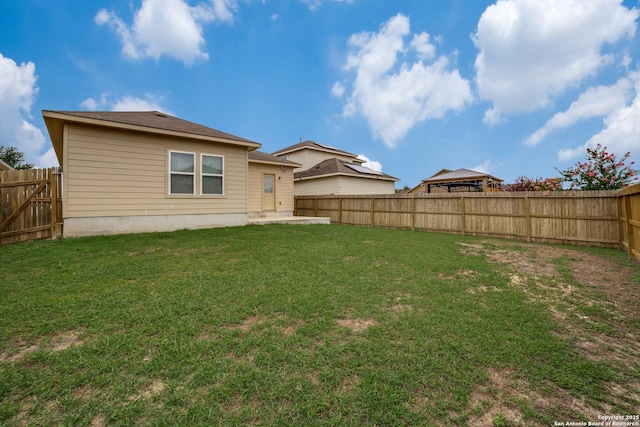 back of property featuring a yard