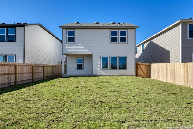 rear view of property with a yard