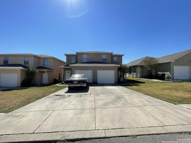 view of property featuring a garage and a front yard