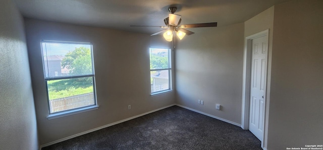 carpeted spare room with ceiling fan and a healthy amount of sunlight