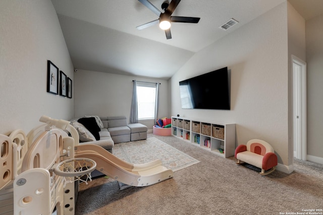 carpeted living room featuring ceiling fan and lofted ceiling