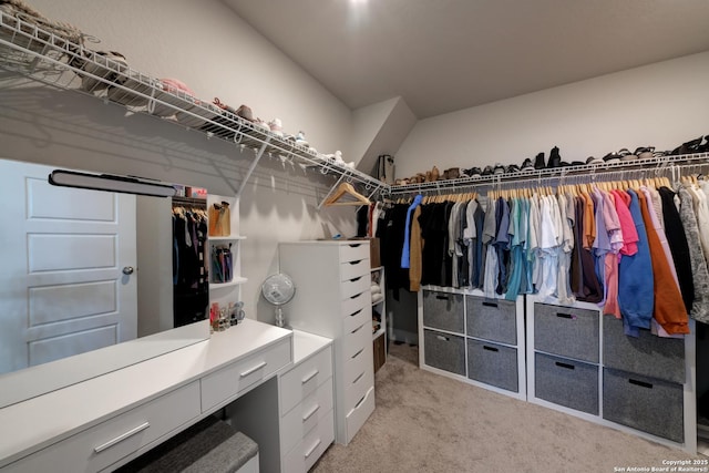 walk in closet featuring light colored carpet