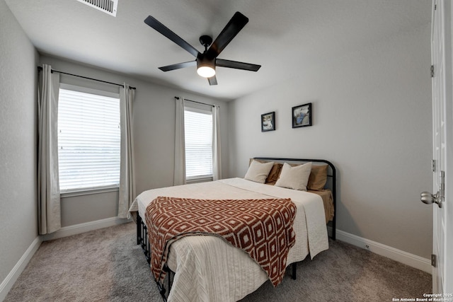 bedroom featuring light colored carpet and ceiling fan