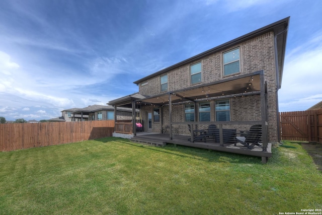 rear view of property with a lawn and a deck