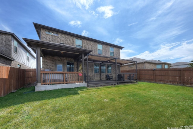 rear view of property featuring a yard and a deck