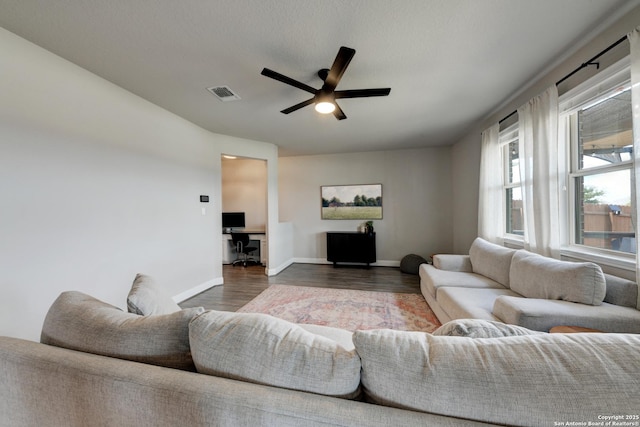 living room with ceiling fan and dark hardwood / wood-style floors