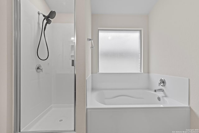 bathroom featuring separate shower and tub