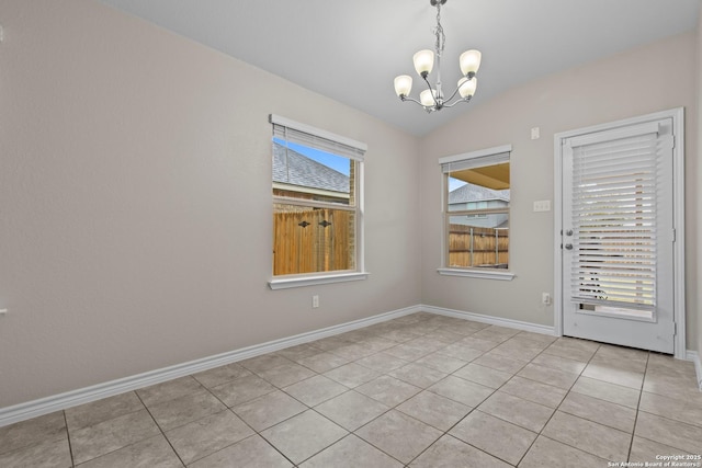 unfurnished room featuring a chandelier, light tile patterned floors, and lofted ceiling