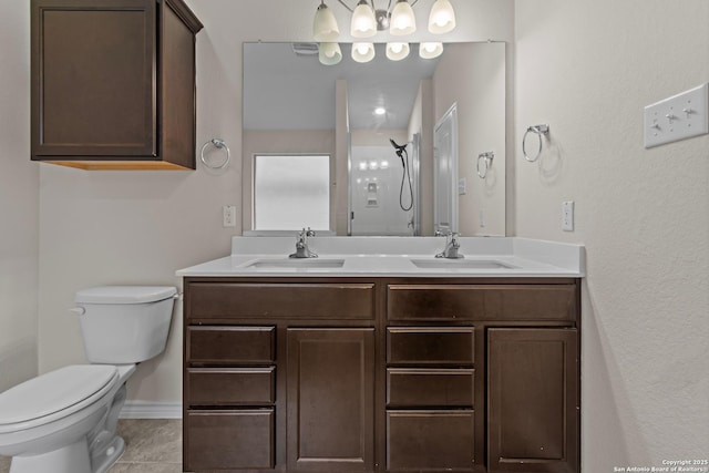 bathroom featuring a shower, vanity, tile patterned floors, and toilet