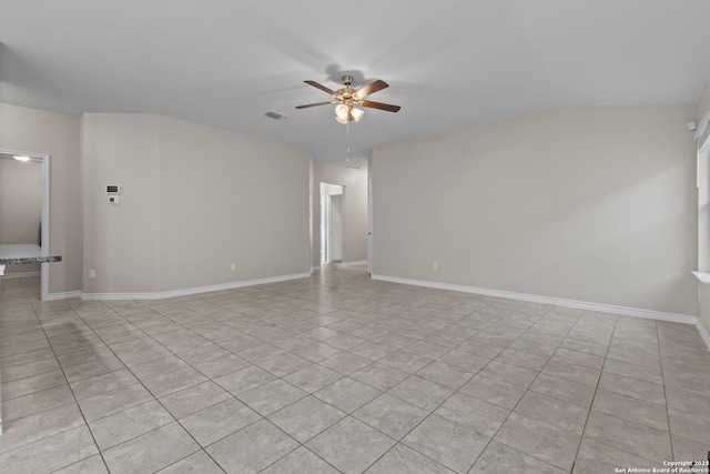 tiled spare room with ceiling fan