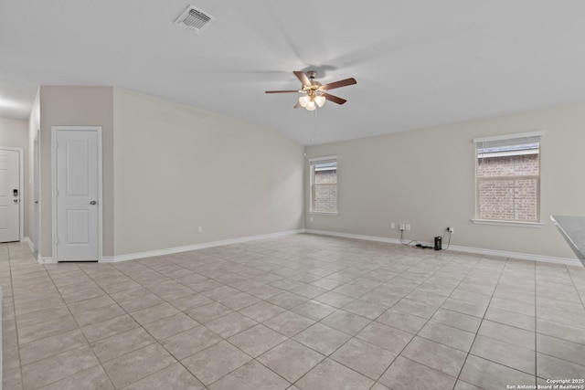 tiled empty room featuring a wealth of natural light and ceiling fan