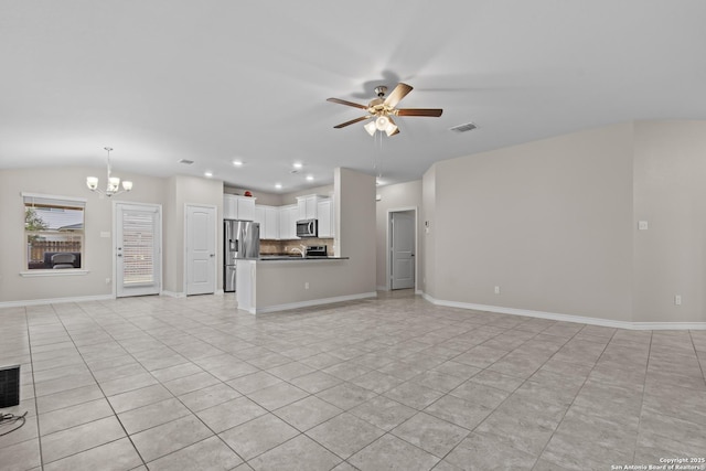 unfurnished living room with vaulted ceiling, light tile patterned floors, and ceiling fan with notable chandelier