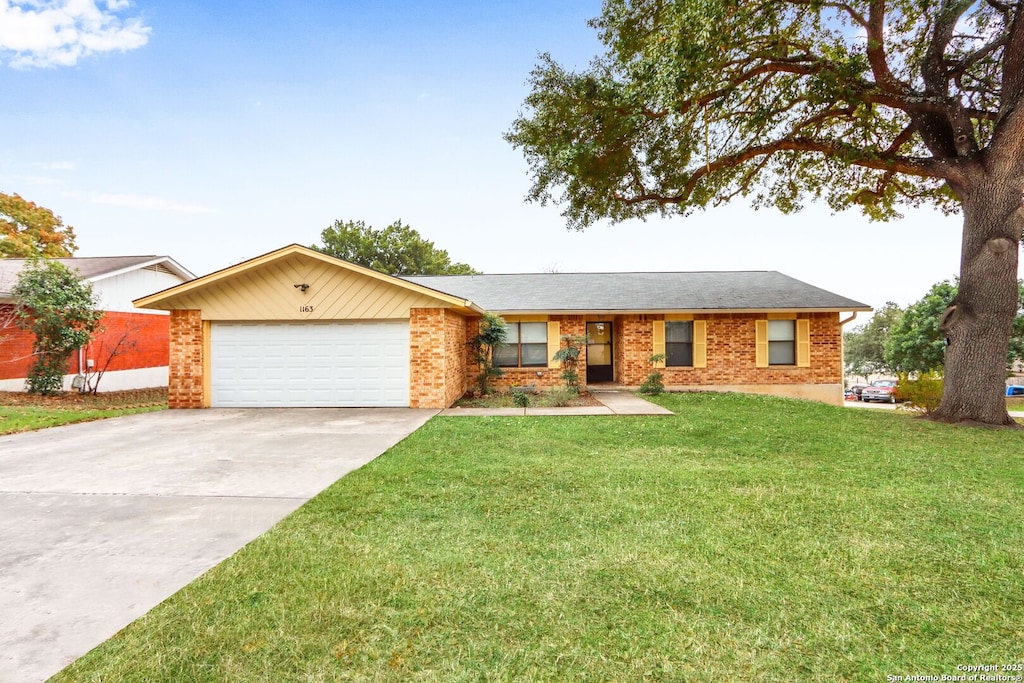 single story home with a garage and a front lawn