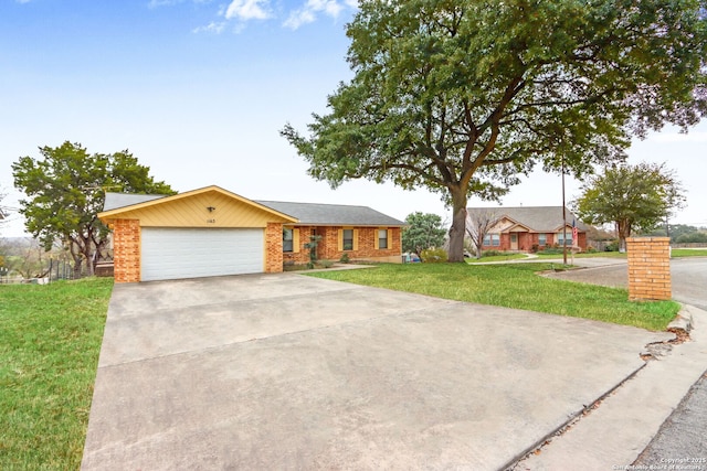 single story home with a garage and a front lawn