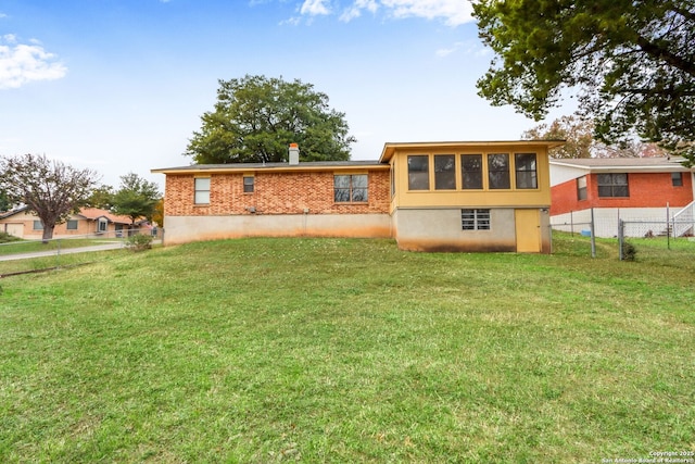 back of house with a yard