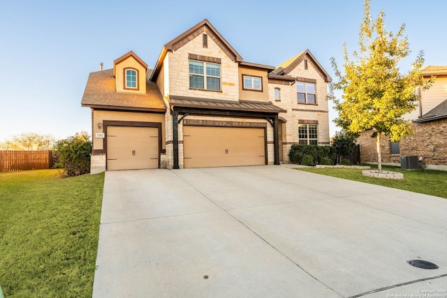 view of front facade with a front yard, central AC, and a garage