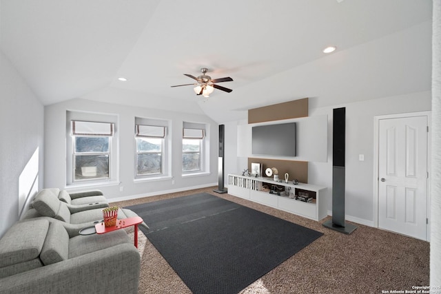 living room featuring ceiling fan, carpet floors, and vaulted ceiling