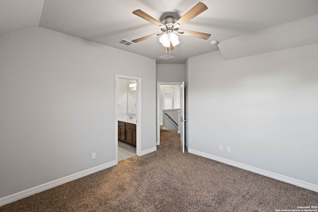 unfurnished bedroom featuring light carpet, ensuite bathroom, ceiling fan, sink, and lofted ceiling