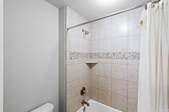 bathroom with shower / tub combo with curtain, a textured ceiling, and toilet