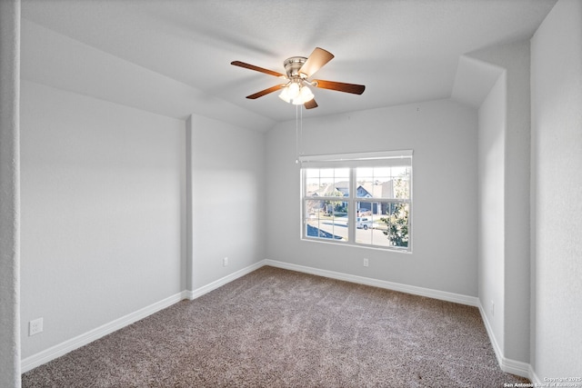 unfurnished room featuring ceiling fan, carpet floors, and vaulted ceiling